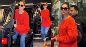 Deepika Padukone keeps it cool in red sweater and denim for airport look; flashes smile before jetting off in style